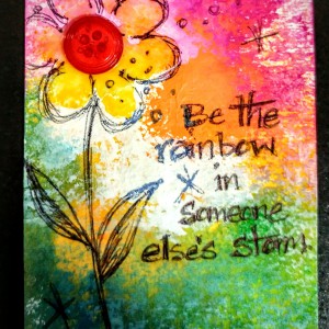 embossed over the bottom of a plastic basket then used my finger to add bumpy texture and dry brush pink glued on a button and drew flower petals with elmer's glue and then used acrylic paint and my finger and sprayed bright yellow watercolor on it before adding pen